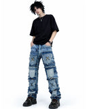 Patchwork distressed denim jeans with layered panel design, worn-in ripped detailing, and bold streetwear-inspired styling.