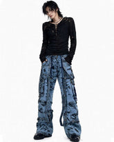 Men’s blue denim cargo pants with chains, buckles, distressed finish, and functional pockets for street style
