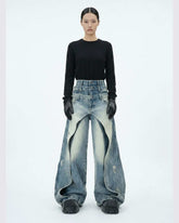 Layered distressed blue jeans with wide-leg silhouette and rugged urban style