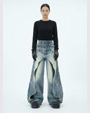 Layered distressed blue jeans with wide-leg silhouette and urban streetwear style