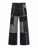 Men’s double denim outfit set with black and grey patchwork jacket and baggy wide-leg jeans front view