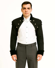 man wearing black swallow tail jacket with ornate buttons and structured shoulders over white shirt and gray pants