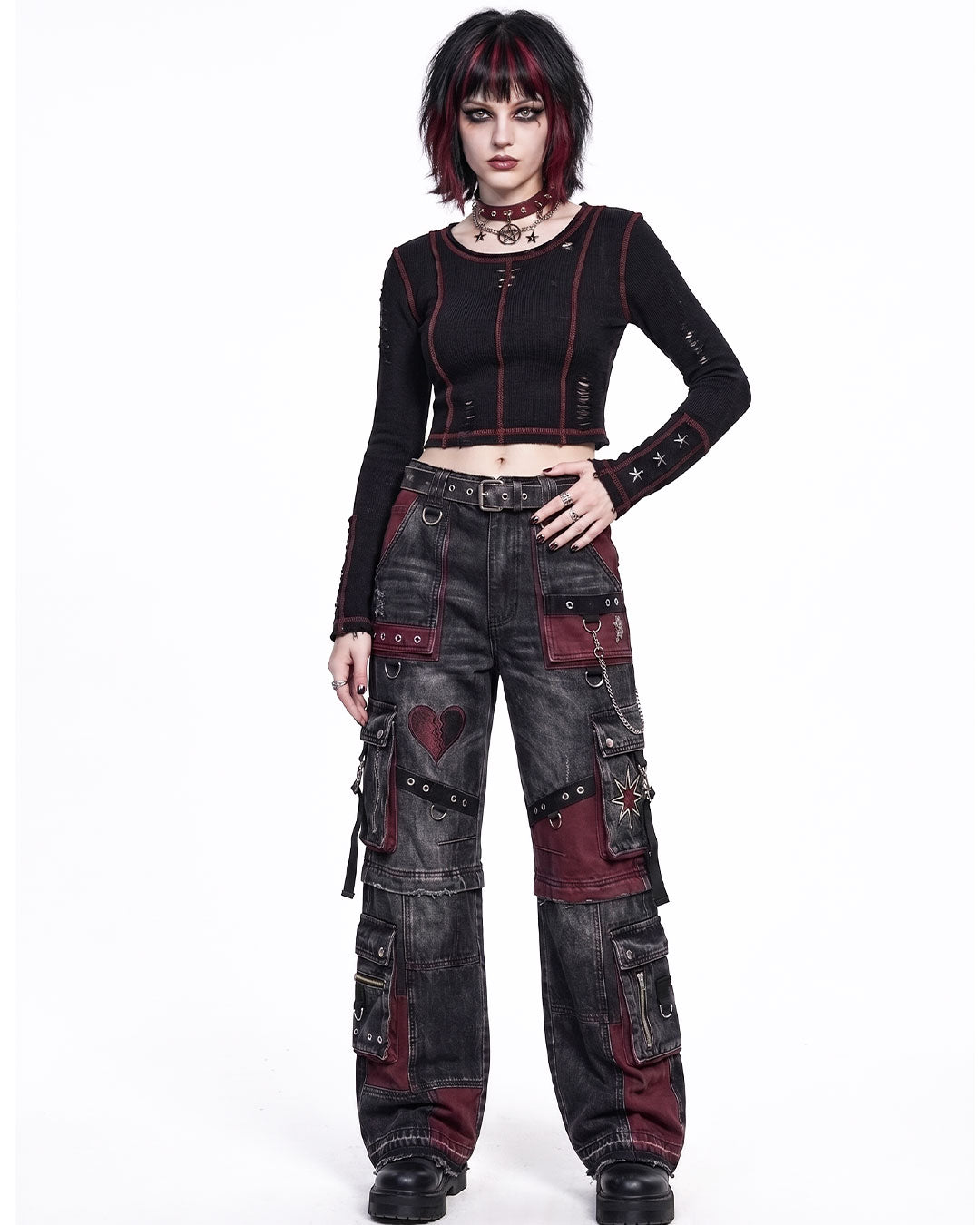 Women's baggy cargo pants front view featuring goth cargo pants design with patchwork details and oversized utility pockets in washed black denim.