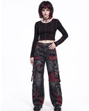 Women's baggy cargo pants front view featuring goth cargo pants design with patchwork details and oversized utility pockets in washed black denim.