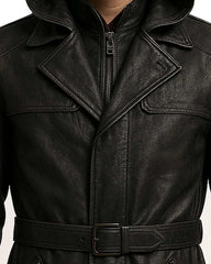 close-up of black genuine leather trench coat with double-breasted front and adjustable belt in streetwear gothic fashion style
