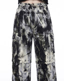 Close-up of the black and white tie dye pattern and utility cargo pocket details on women’s wide leg pants.