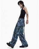 Men’s blue denim cargo pants with chains, buckles, distressed finish, and functional pockets for street style