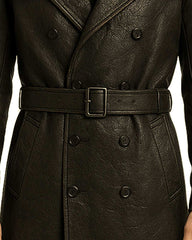 Close-up of black gothic cross leather trench coat with double-breasted buttons and belted waist