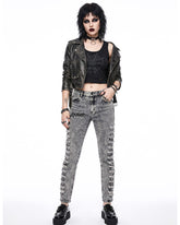 Woman wearing grey skinny jeans women with ripped thigh detailing, styled with black leather jacket and choker