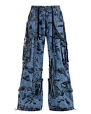 Men’s blue denim cargo pants with metal chains, buckles, distressed finish, and functional pockets