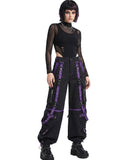 Woman wearing black punk cargo pants with purple buckle straps, front view