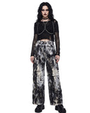 Model wearing women’s black and white tie dye wide leg cargo pants with utility pockets, front view.