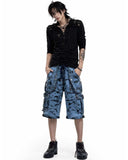 Men’s blue denim cargo pants with silver chains, buckles, distressed finish, and multiple cargo pockets for a stylish, edgy streetwear look