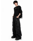 Male model wearing black grunge cargo pants side pose