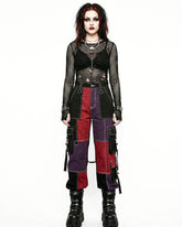 Person wearing a gothic-inspired outfit with a black top, red and purple pants, and black boots on a white background.