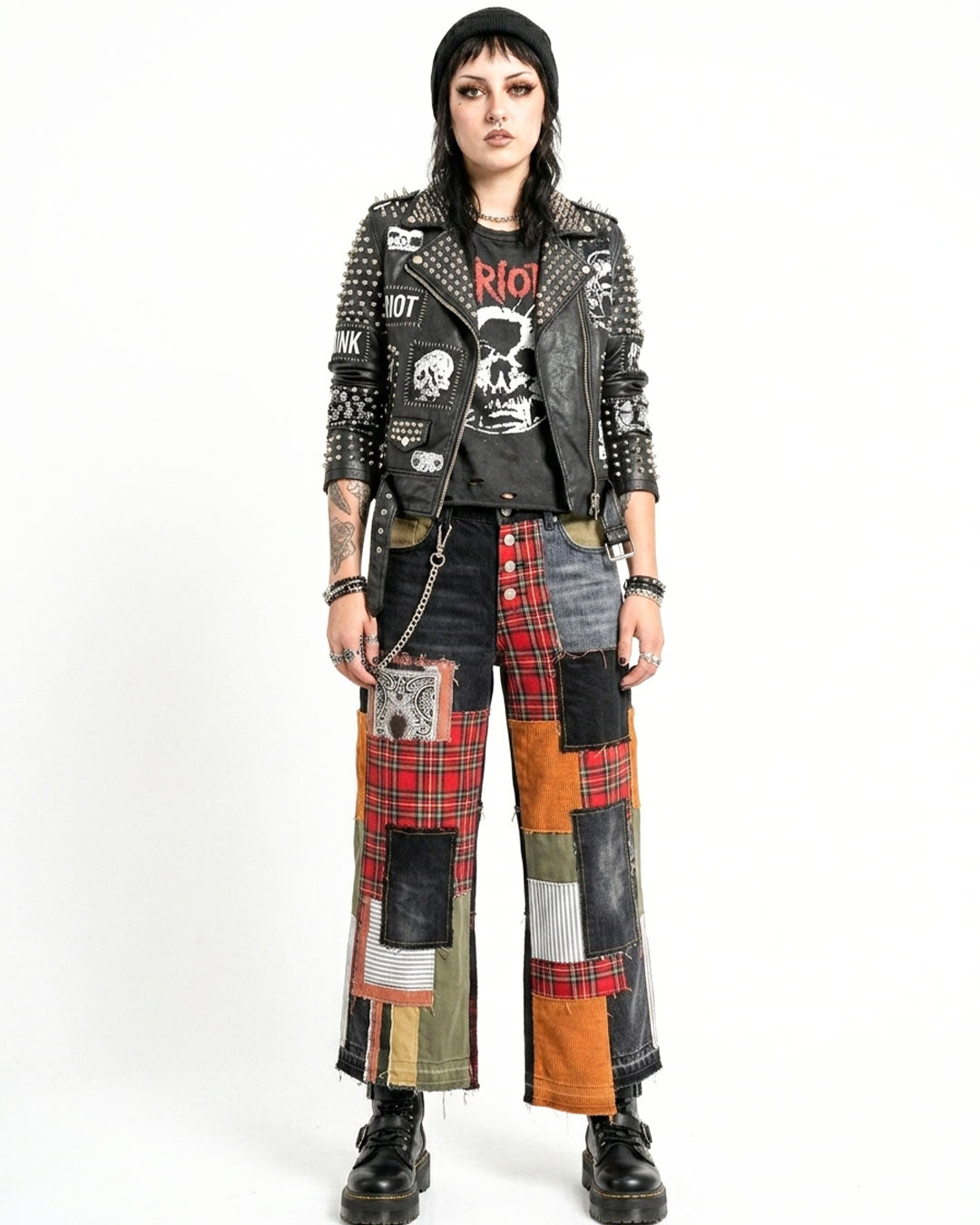 Person wearing a patchwork jacket and pants with a white background