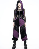 Person wearing a gothic outfit with purple and black colors on a white background