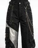 Close-up of black cargo pants women showing premium fabric, metal D-rings, detachable chain, embroidery, and utility pocket details.