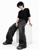 Black baggy cargo jeans for men with oversized fit, washed black denim look, and multiple utility flap pockets in streetwear style.