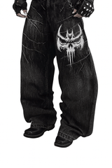 Unisex Gothic Skull jeans in vintage washed black denim with large white embroidered skull and relaxed wide-leg fit