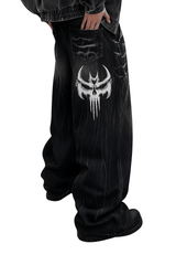 Unisex Gothic Skull jeans in vintage washed black denim with large white skull embroidery and relaxed wide-leg fit