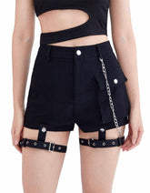 High waist black denim mini shorts with buckle straps and chain detail on model