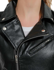 Close-up of women's black moto leather vest with zippered front and silver hardware details