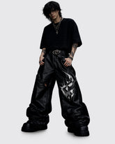 Nightfang men's black gothic leather pants with wide-leg fit and bold front graphic, front view
