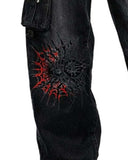 Denim cargo pants for women in black with utility pockets and bold red gothic graphic artwork shown in lifestyle front view and back view.
