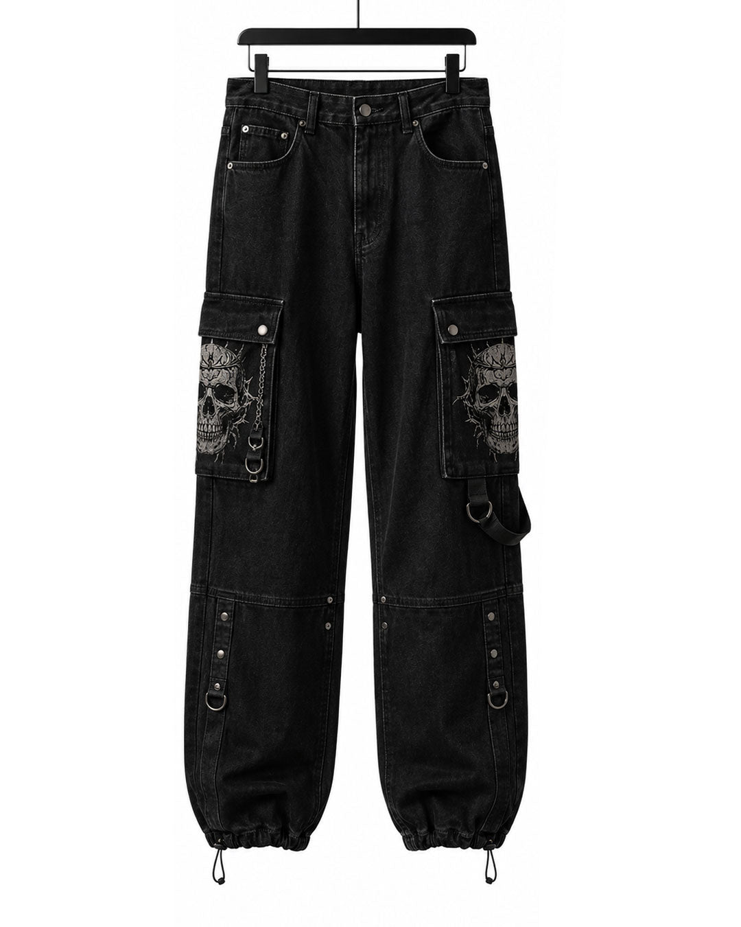 Flat lay of baggy cargo pants in washed black denim with skull pocket print and drawstring hem