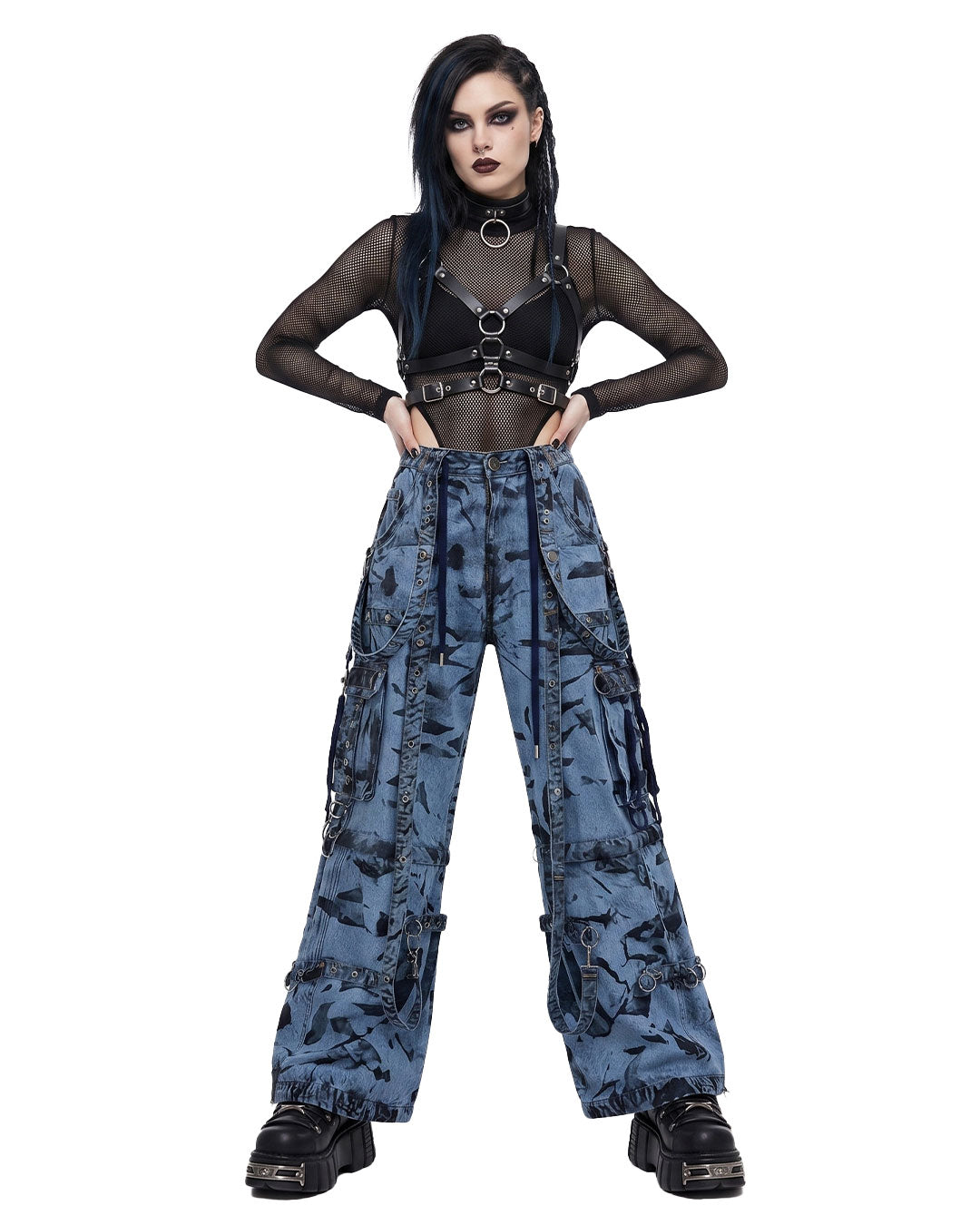 Woman wearing wide leg cargo jeans, baggy cargo pants women, tie-dye denim wash, front view with harness top