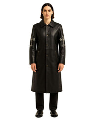 Black Gothic Cross long leather coat with silver cross embroidery on sleeves, button closure, and zippered pockets.