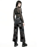 Person wearing a black, sheer top and patchwork pants on a white background