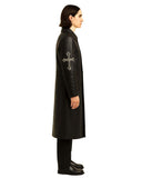 Side view of Gothic Cross Long Leather Coat in black with silver cross embroidery on sleeve worn by model