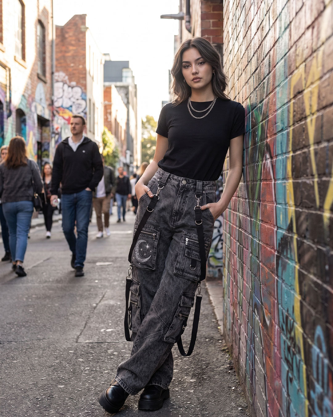 Lifestyle photo of Baggy Cargo Jeans Women styled with streetwear fashion featuring washed black wide leg cargo jeans.