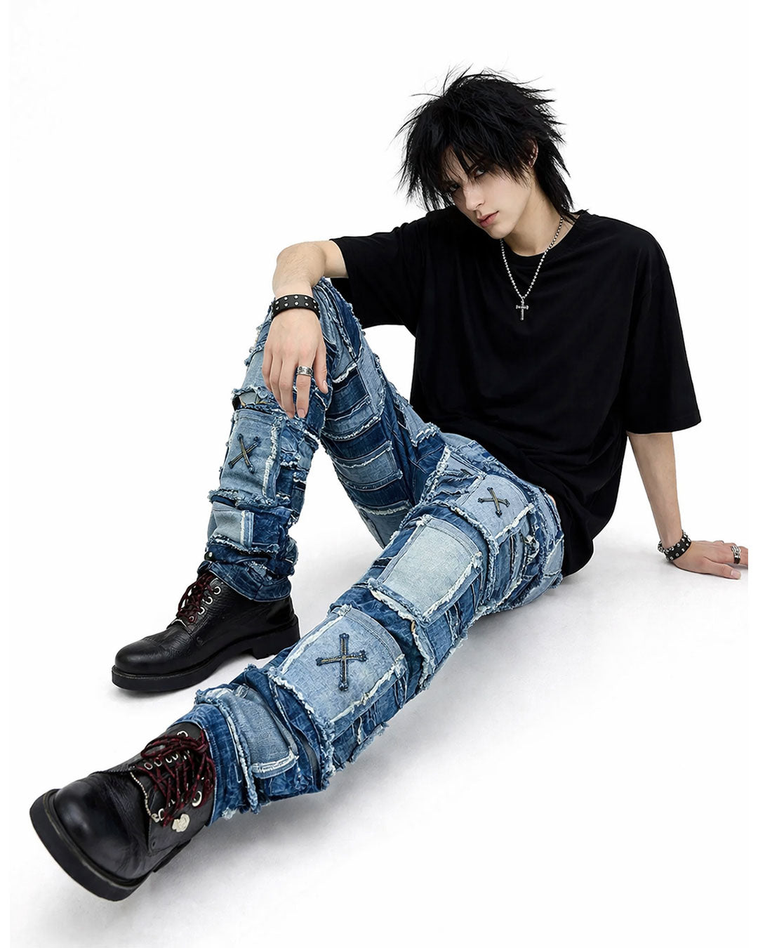 Patchwork distressed denim jeans with layered panel design, worn-in ripped detailing, and bold streetwear-inspired styling.