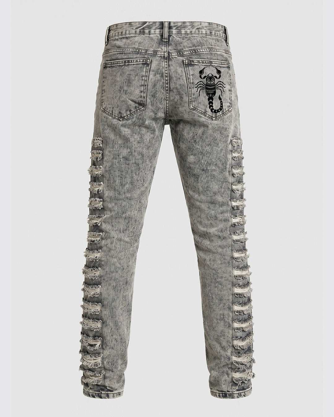 Close-up of distressed rips on men's grey acid wash skinny jeans
