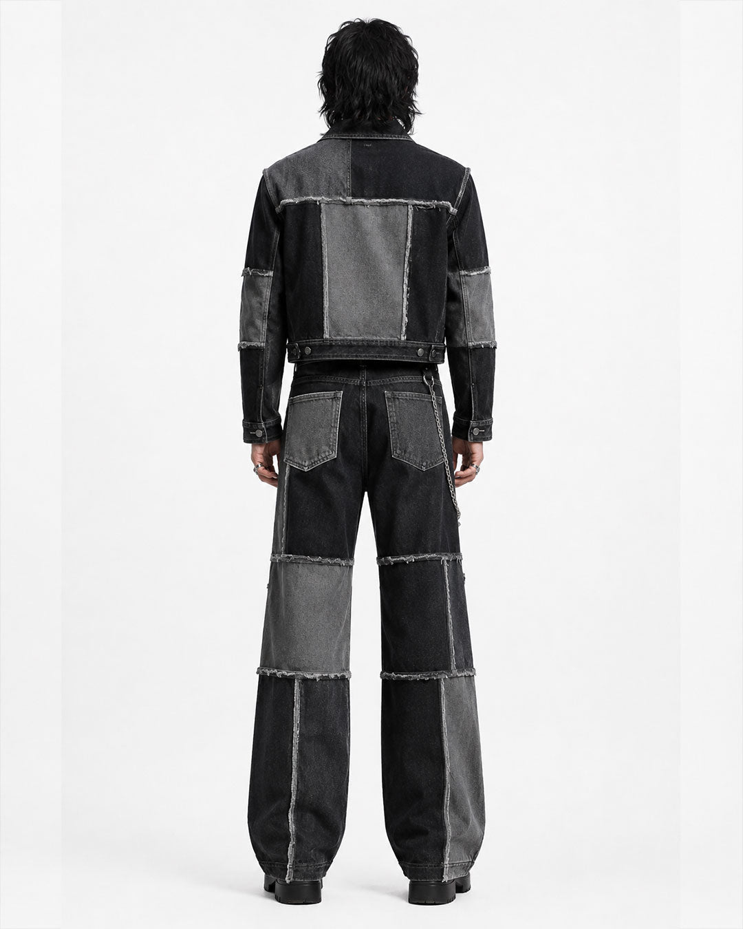 Men’s double denim outfit set with black and grey patchwork jacket and baggy wide-leg jeans front view