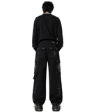 Baggy men black jeans styled with oversized sweatshirt, back view showing patch pockets