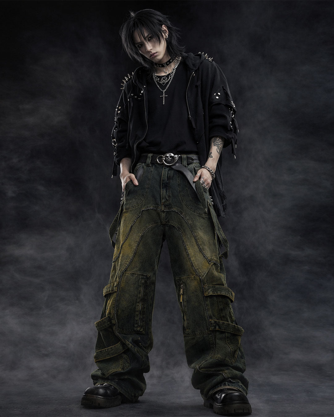 Mens baggy cargo jeans in washed dark denim with wide-leg fit, utility straps, curved seam panels, and streetwear styling shown in product and model view.