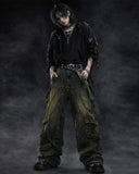 Mens baggy cargo jeans in washed dark denim with wide-leg fit, utility straps, curved seam panels, and streetwear styling shown in product and model view.