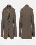 A brown tweed blazer shown from both the front and back views against a plain white background. The blazer features brown suede elbow patches and a satin lining.