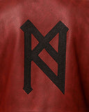Close-up of black gothic embroidery on maroon leather trench coat from TRIPPPRS Premium Collection