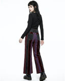 Person wearing a black top and striped pants on a white background