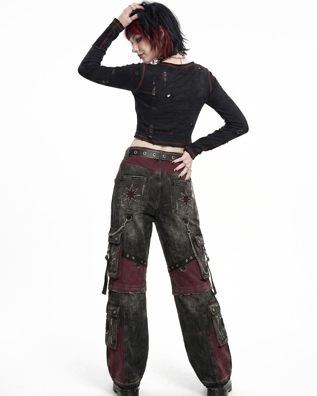 Back view of women's baggy cargo pants with oversized cargo pockets, gothic patchwork panels, and relaxed wide-leg fit.