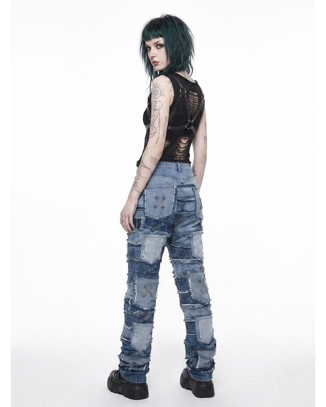  Back view of patchwork jeans women with distressed denim patches and raw hem detailing on model