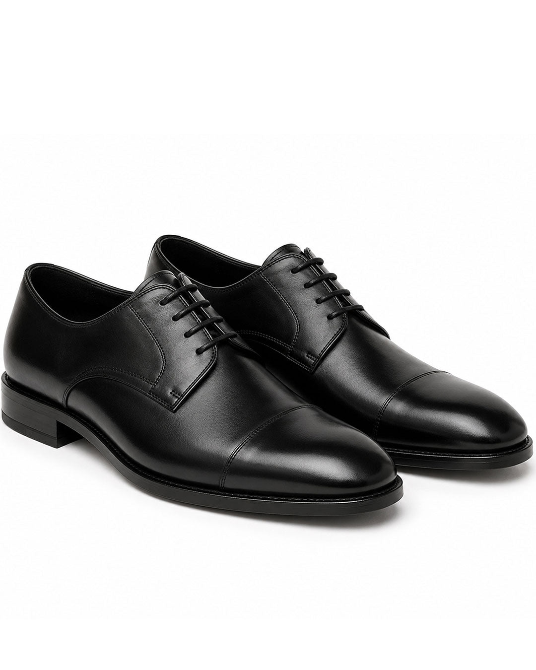 A pair of black leather cap-toe oxford shoes with matching black laces, displayed on a clean white background.