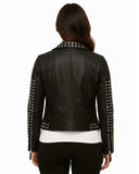 Back view of a woman wearing a black studded leather jacket with silver studs on collar, sleeves, and waist