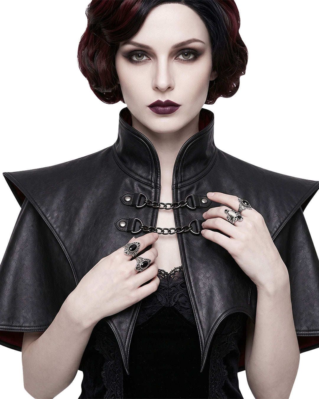 Women’s black gothic leather shoulder cape with high collar, pointed shoulders, chain closures and deep-red inner lining, front view