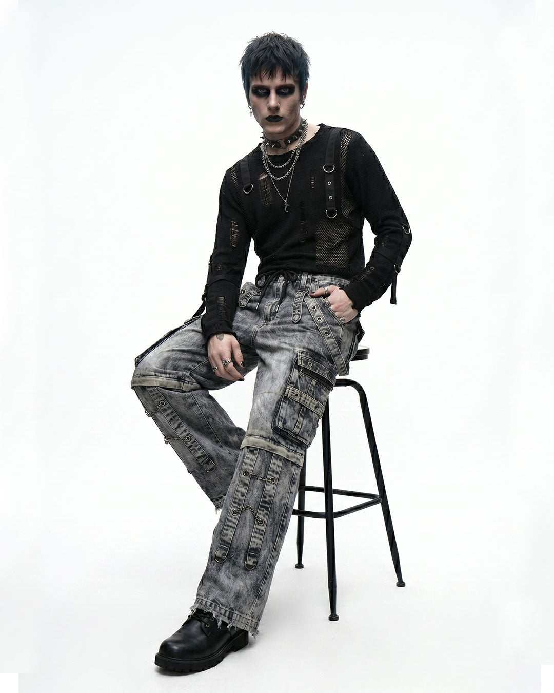 Men's baggy denim cargo pants with strap detailing and flap pockets, side view